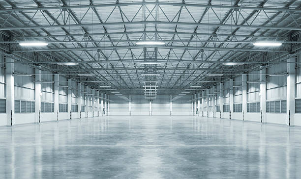 Empty factory with concrete floor, night scene.